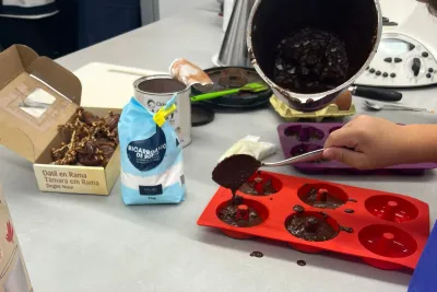 Vertiendo la masa de los donuts en los moldes.